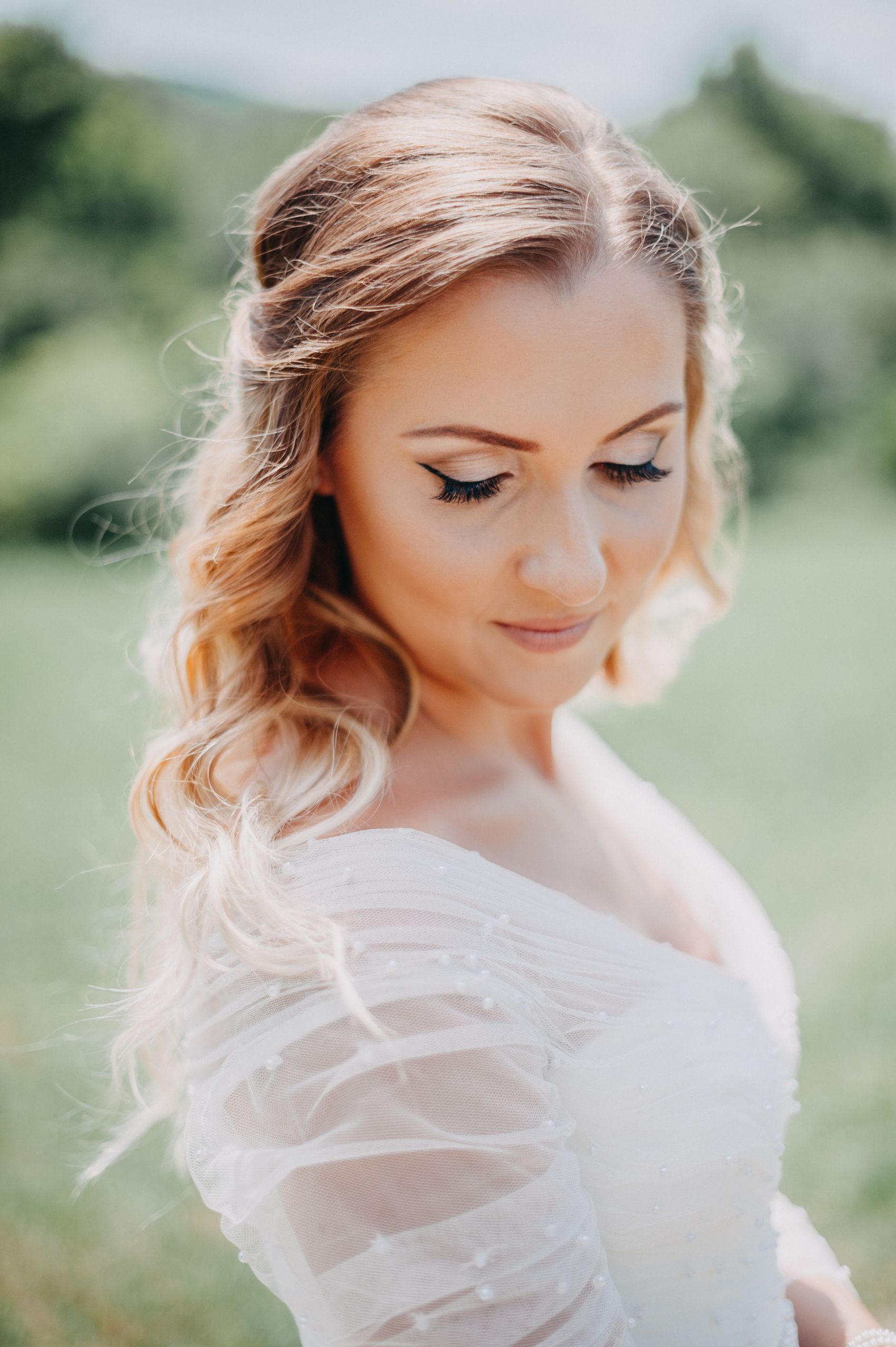 Beautiful bridal portrait in a park on a sunny day highlighting natural elegance and serene beauty.